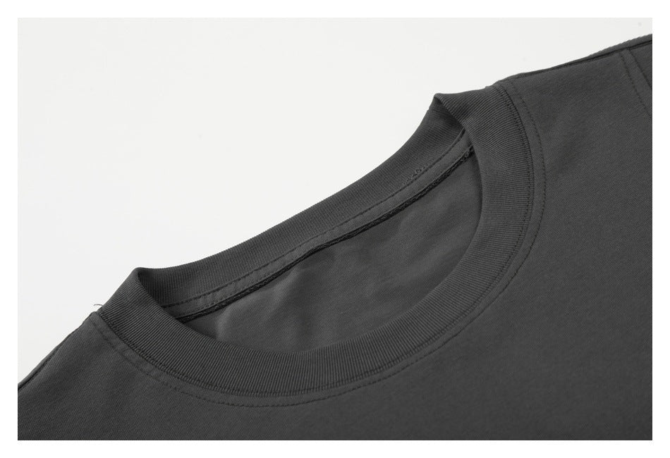 Close-up of the charcoal T-shirt’s ribbed crew neckline and inner collar seam.