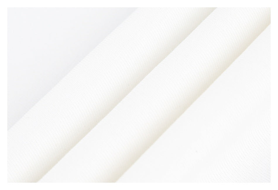 Close-up of white fabric folded into two diagonal bands, showing its fine knit texture.