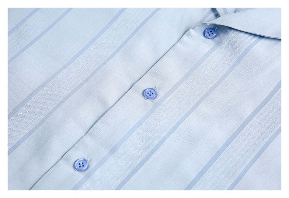 Light blue striped shirt placket shown close-up with three blue buttons.