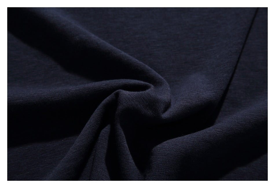 Close-up showing the dark navy garment fabric draped into soft folds.