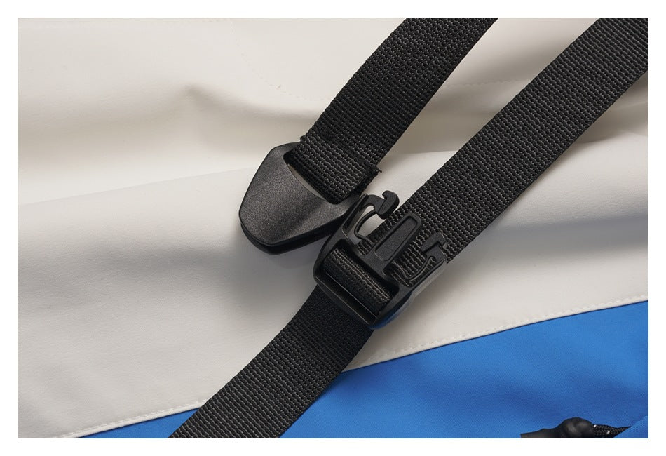 Close-up of the black webbing belt and plastic buckle against the white and blue pants.