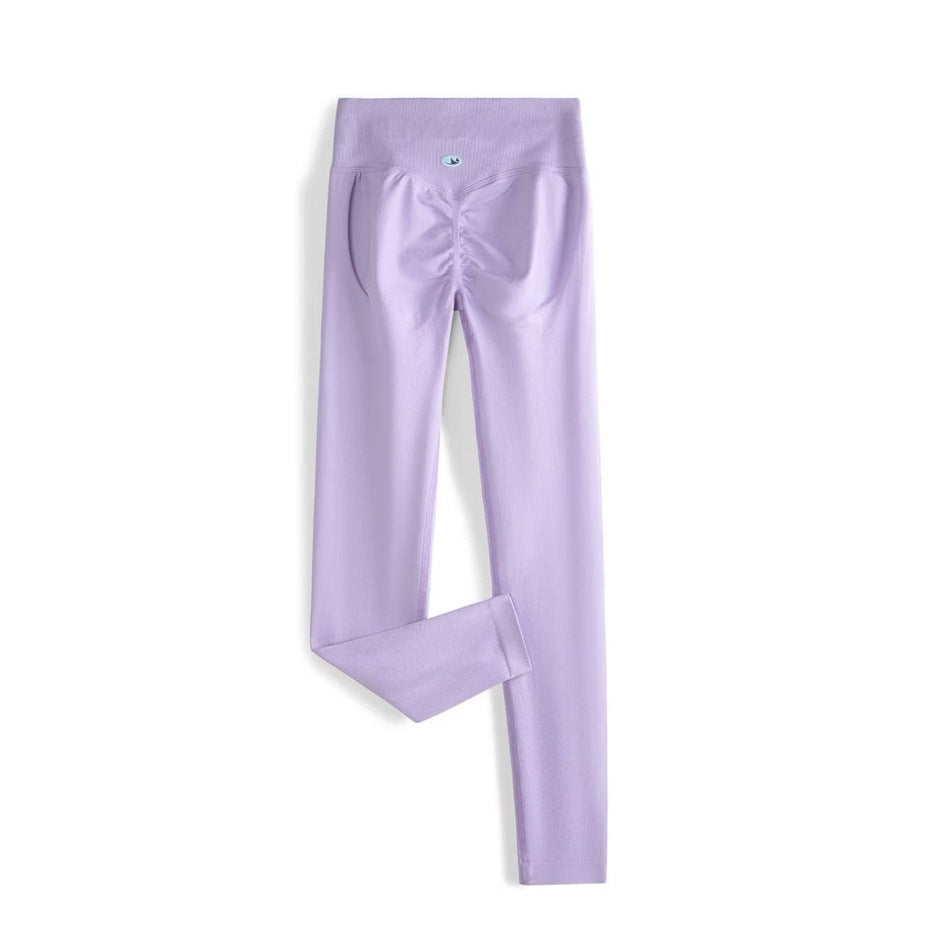 Back view of lavender full-length leggings with a wide high-rise waistband and ruched seat seams.
