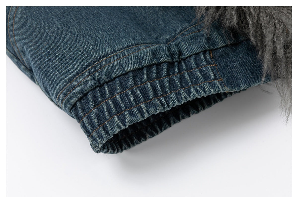 Close-up of a gathered elastic denim jacket edge beside gray shaggy trim.