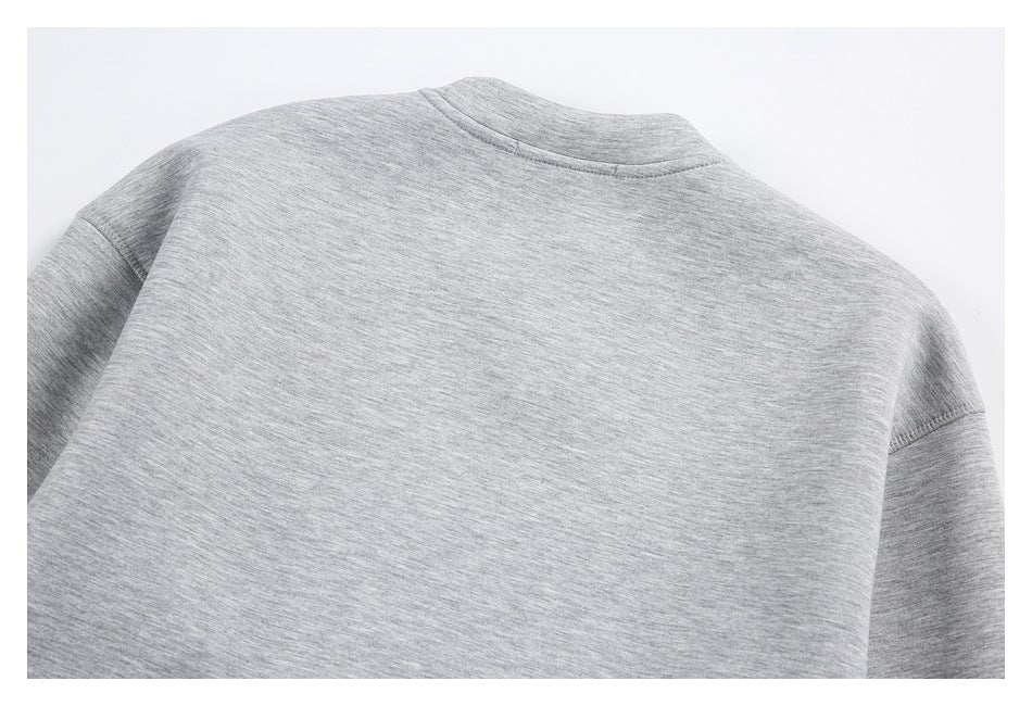 Back view of a gray heather sweatshirt laid flat, showing its crew neckline and long sleeves.