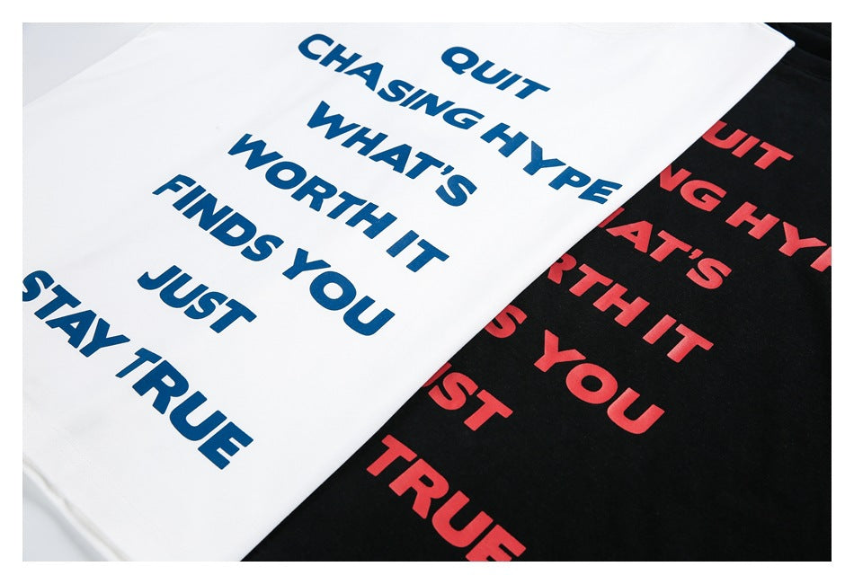 White and black T-shirts with bold motivational text printed in blue and red.