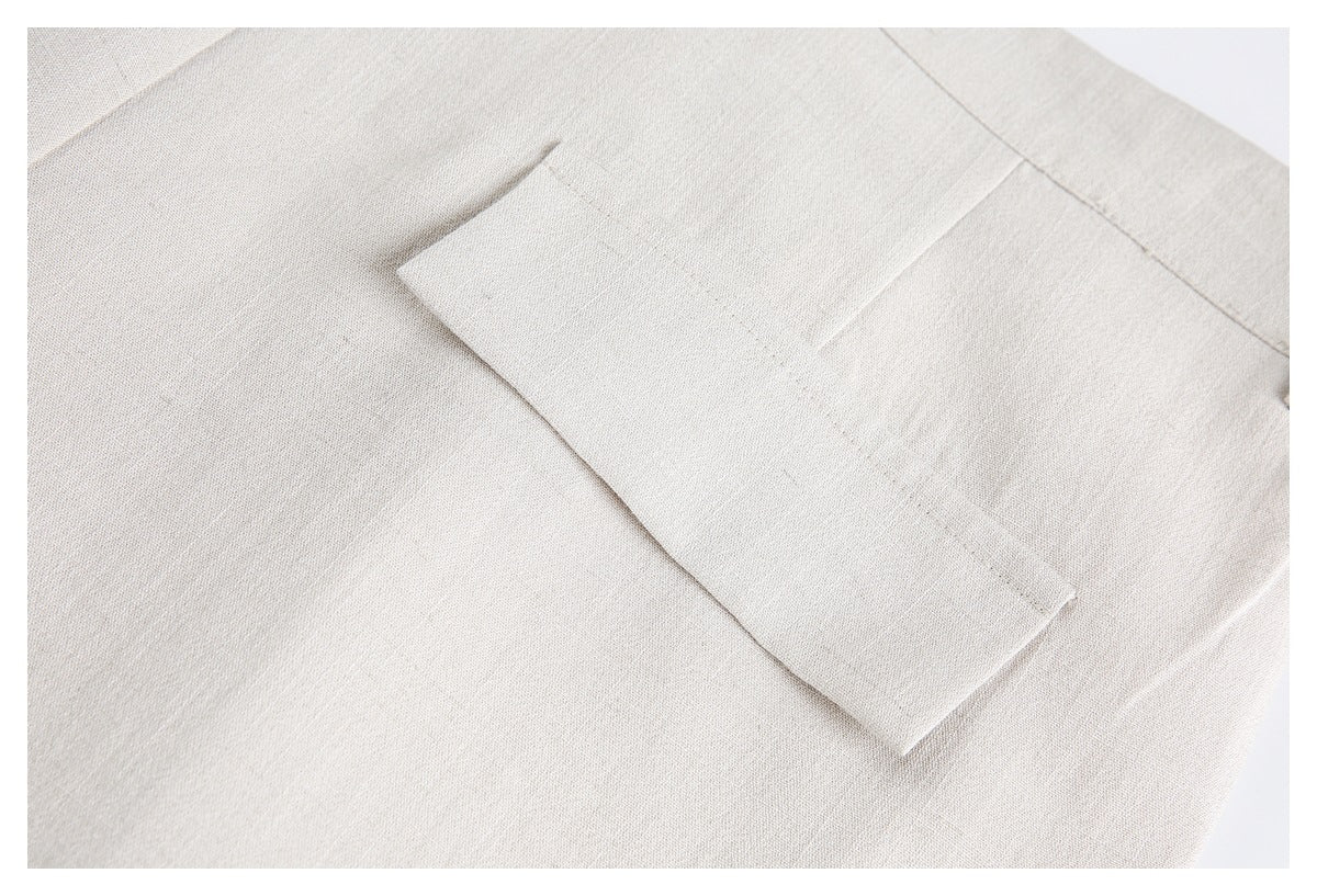 Close-up of a rectangular pocket on light beige trousers.