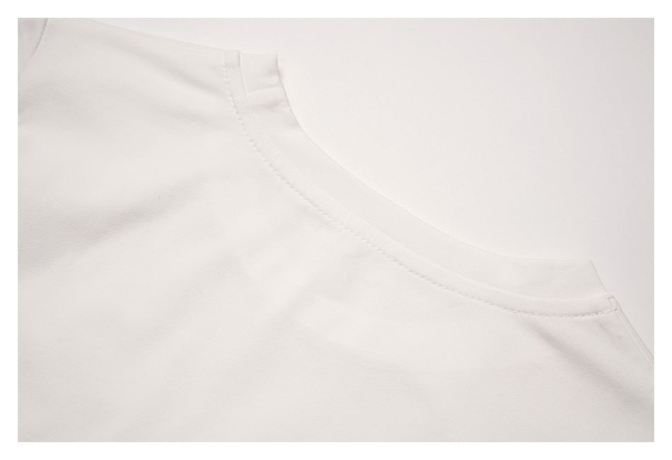 Close-up of a white garment's rounded neckline and stitched collar seam.