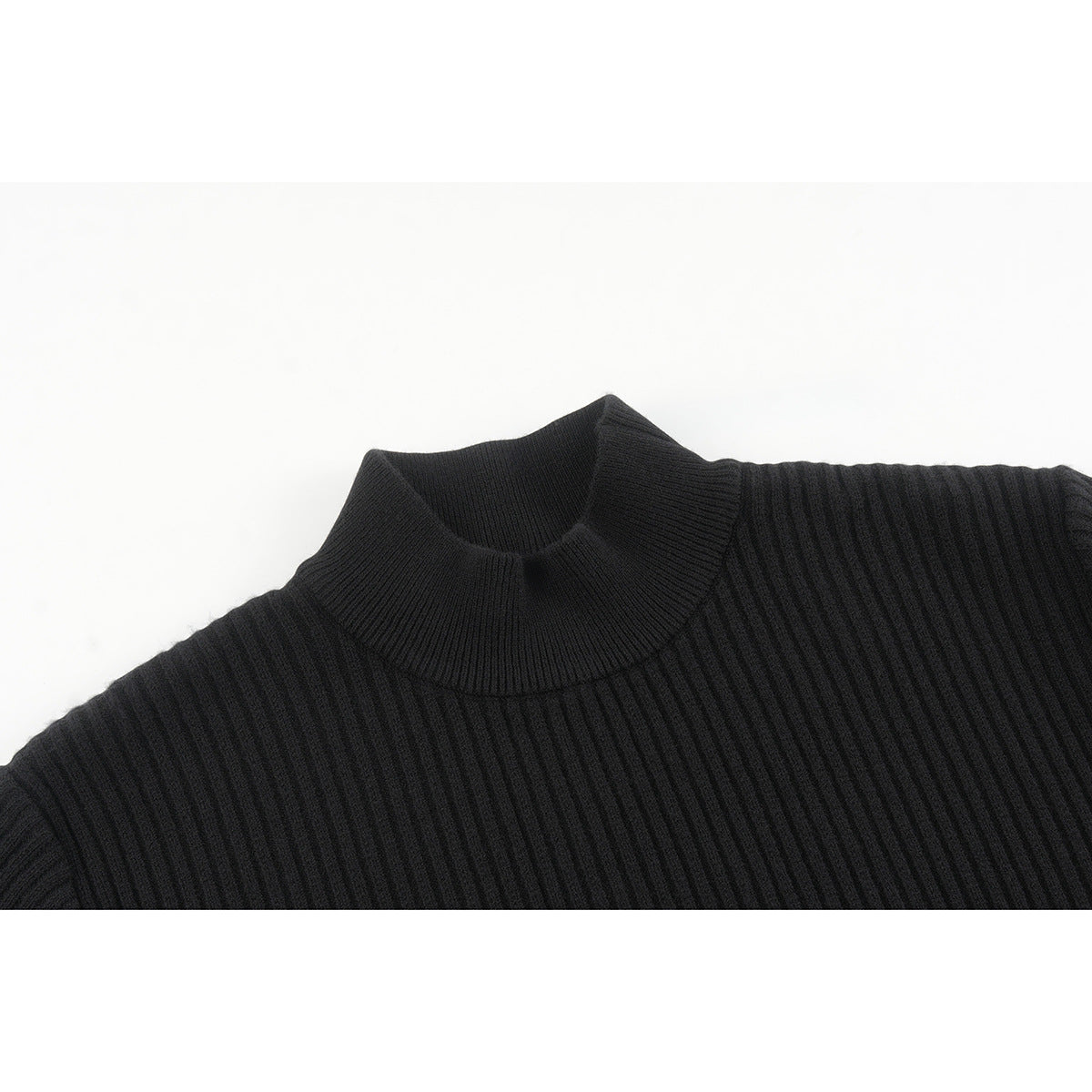 Close-up of a black ribbed knit sweater showing its high crew neckline and shoulder.