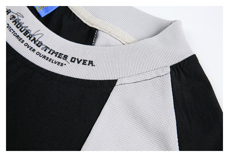Close-up of the shirt collar and shoulder seam, showing black and light gray panels.