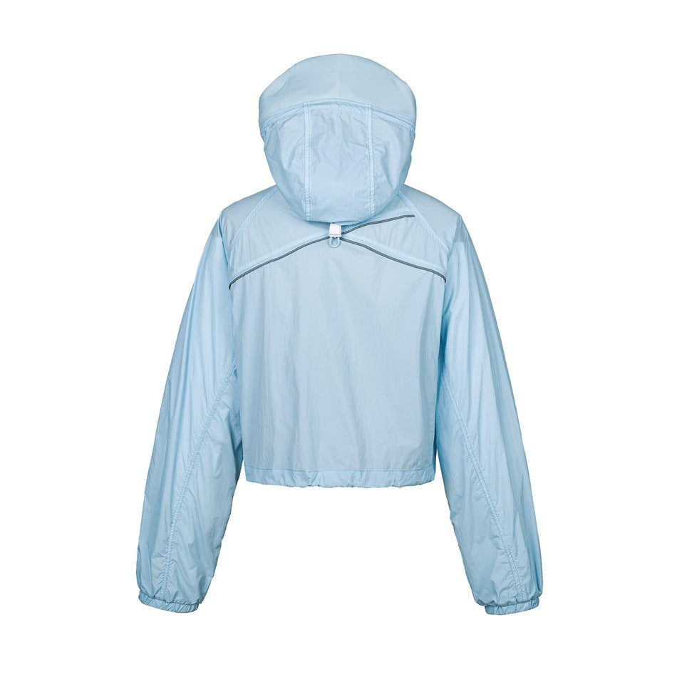 Back view of light blue cropped hooded jacket with gray piping across the yoke and hood cord toggle