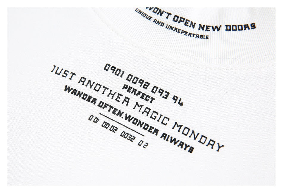 Close-up of black English lettering printed across the chest of a white T-shirt.