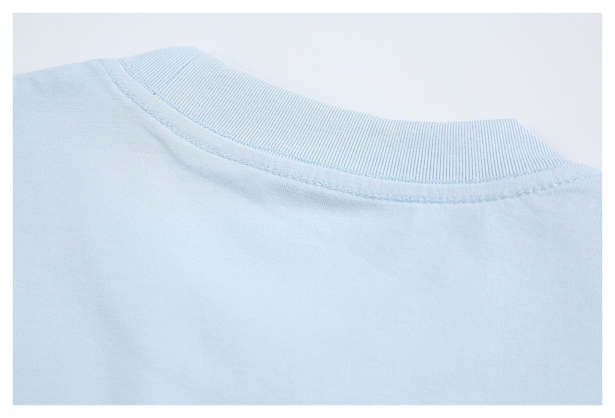 Close-up of a light blue crew neckline with ribbed trim and visible stitching.