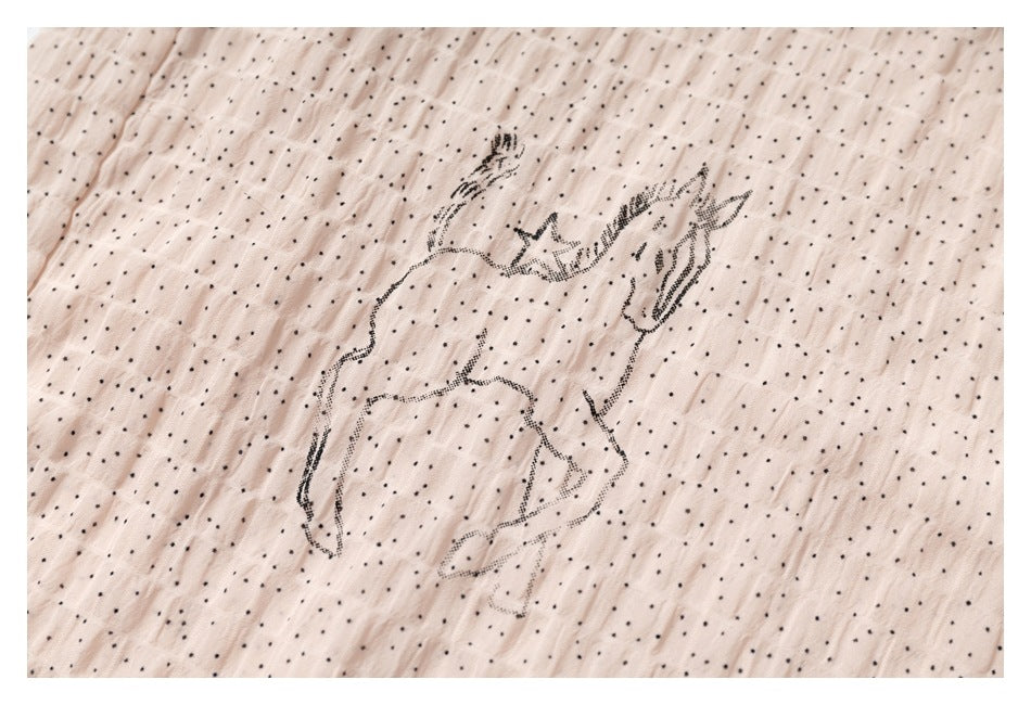 Unicorn illustration on pale blush fabric with a tiny black dot pattern.