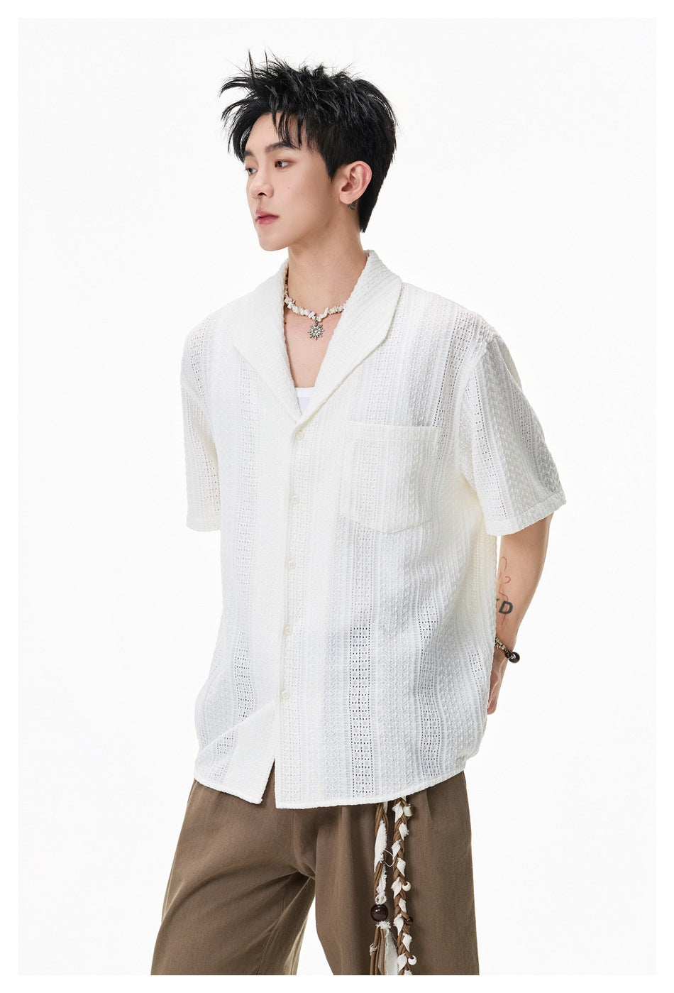 Model wearing a white openwork short-sleeve shirt, shown at a slight side angle with its button front and chest pocket