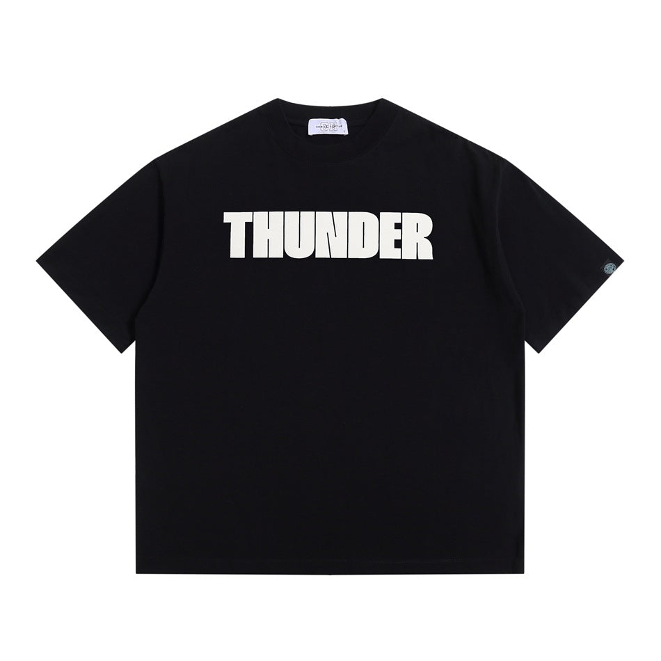Black short-sleeve crew-neck T-shirt with large white THUNDER block-letter print on chest, flat lay
