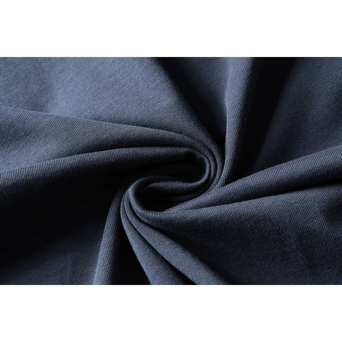 Close-up of slate-blue knit fabric gathered into soft folds.