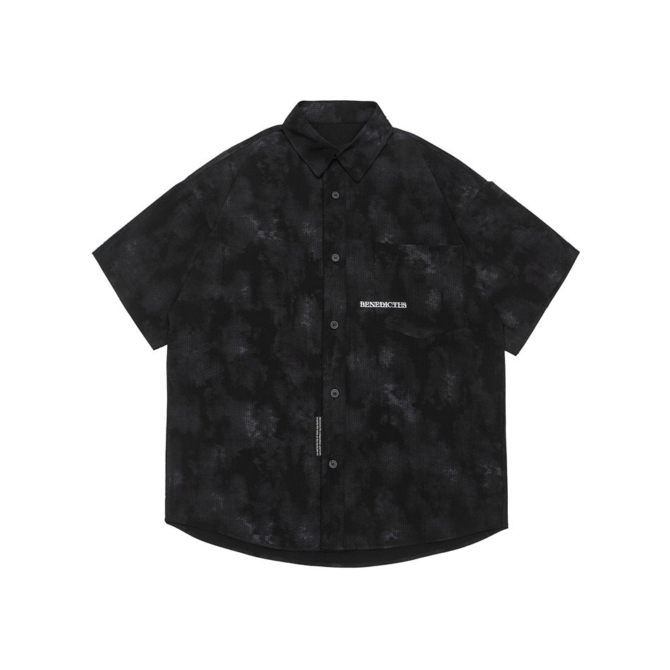 Black short-sleeve button-up shirt with mottled gray distressed pattern, chest pocket and collar, flat lay front view