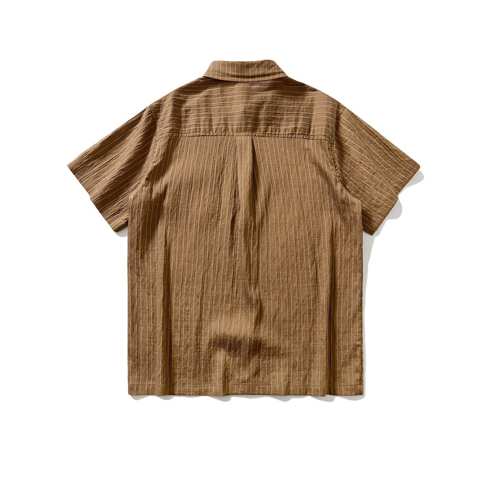 Back view of brown short-sleeve shirt showing yoke seam, center pleat and fine vertical stripes
