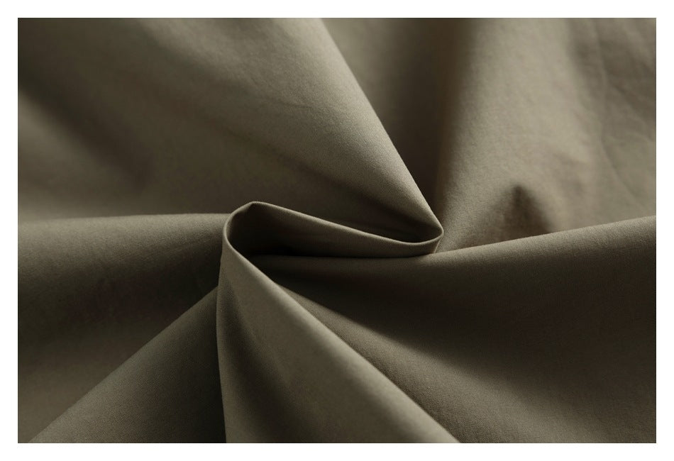 Olive-gray fabric shown in a close-up, folded into soft draped peaks.