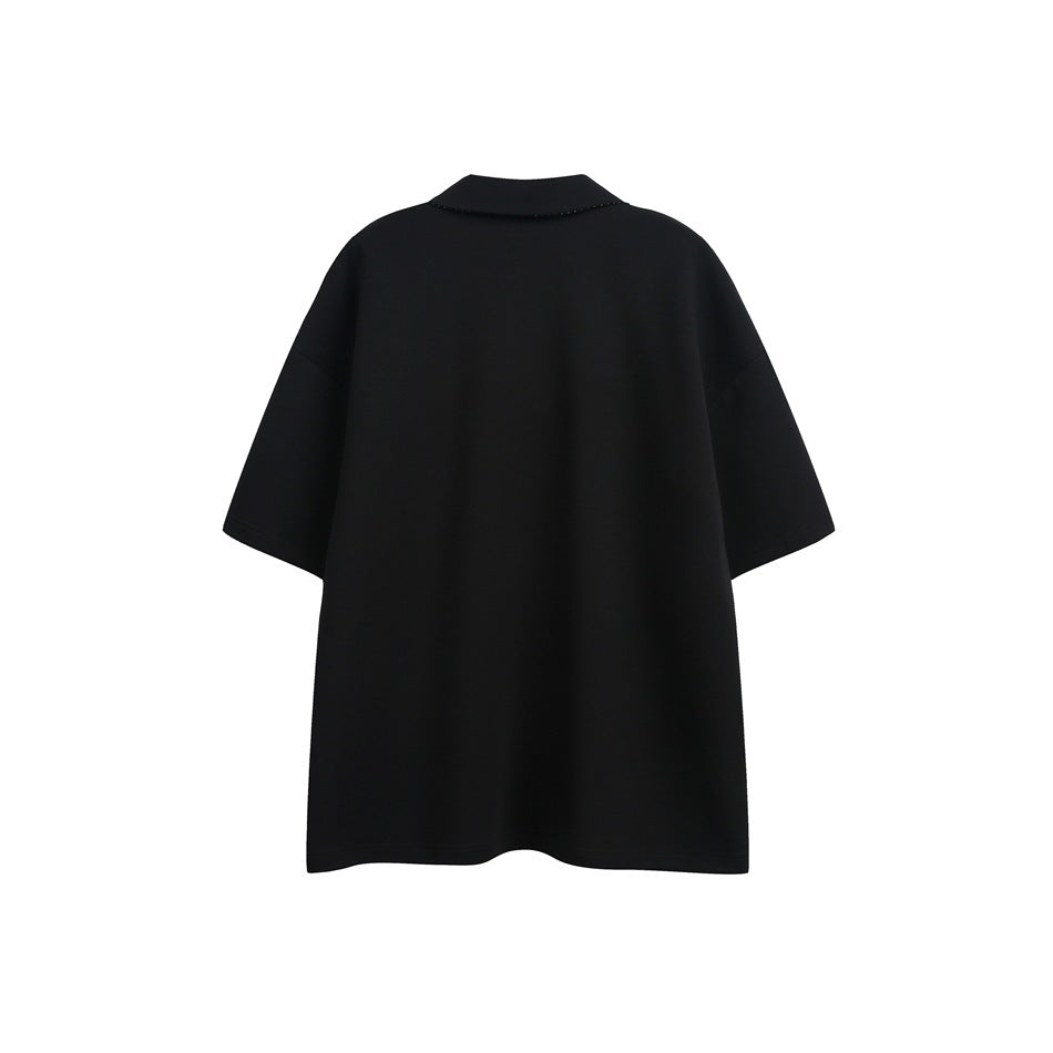 Back view of a black oversized short-sleeve polo with a simple collar.