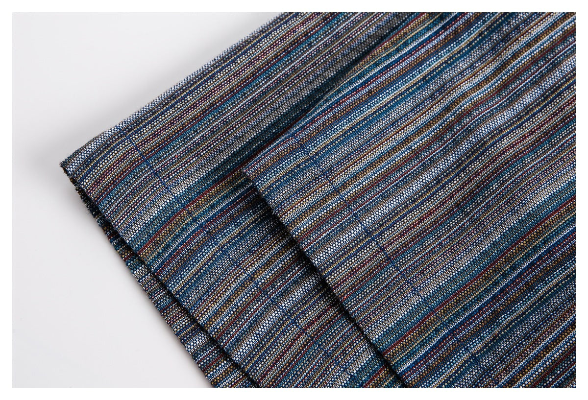 Close-up of a multicolored narrow-striped woven garment edge with a folded, stitched seam.