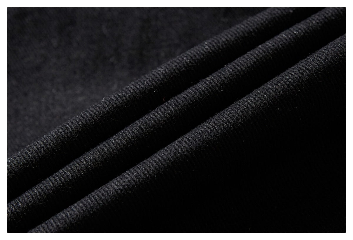 Extreme close-up of the textured black fabric folded into ridges.