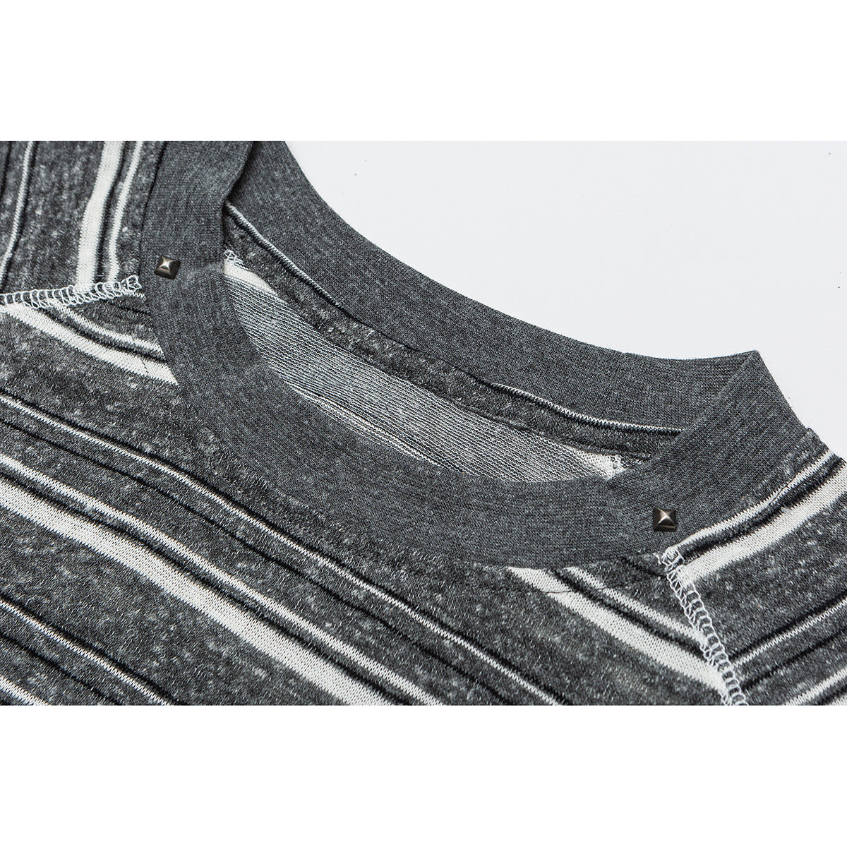 Close-up of a charcoal gray striped shirt neckline with contrast stitching and small metal studs.