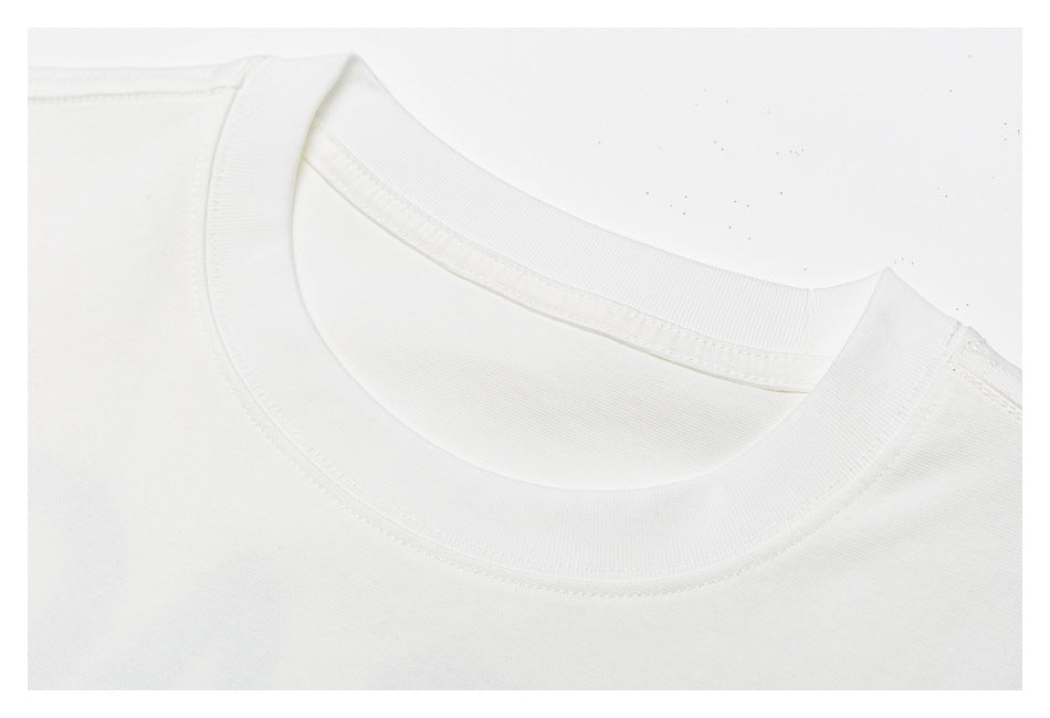 Close-up of the white T-shirt's ribbed crew neckline and stitched collar.
