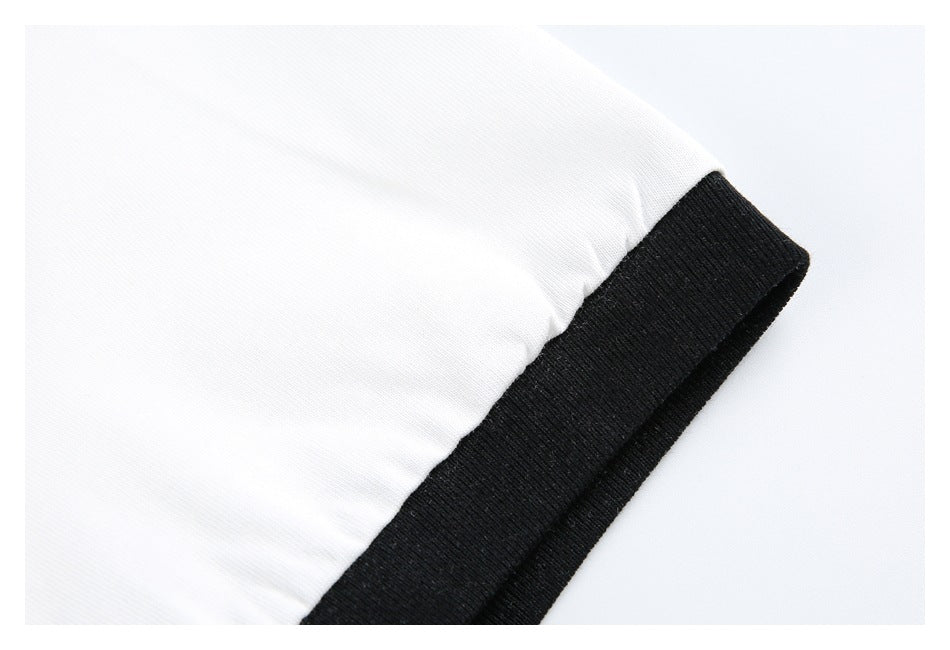 Close-up of a white sleeve ending in a wide black ribbed cuff.