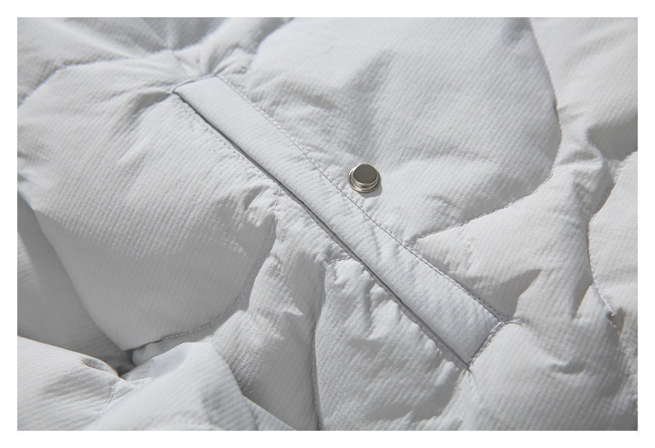 Close-up of quilted jacket stitching and a metal snap on the front placket.