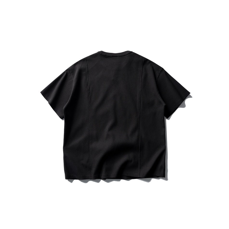 Back view of black waffle-textured short-sleeve T-shirt, flat lay, with vertical seam lines