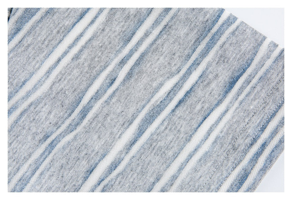 Close-up of the striped fabric and stitched short-sleeve hem.
