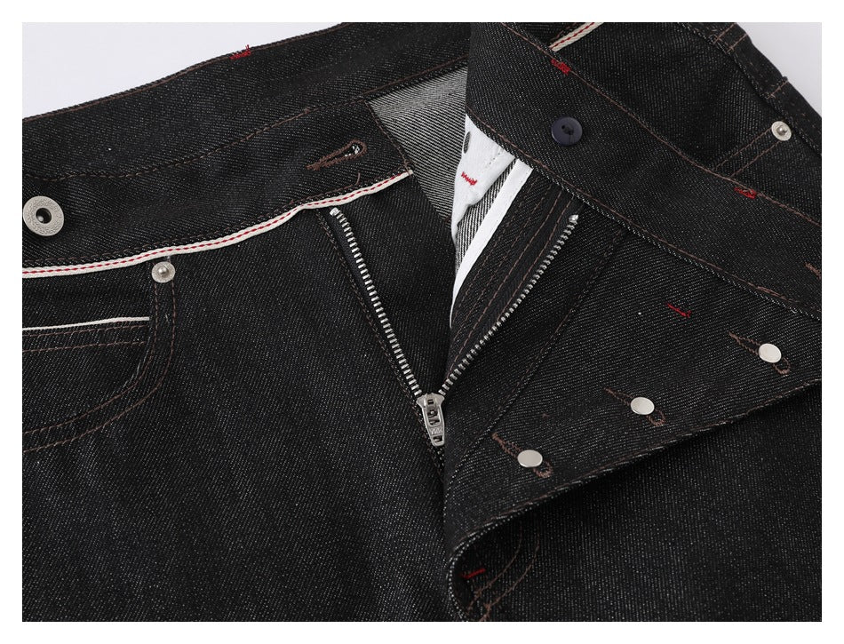 Close-up of black denim jeans with the fly open, showing the zipper, button, and front pocket details.