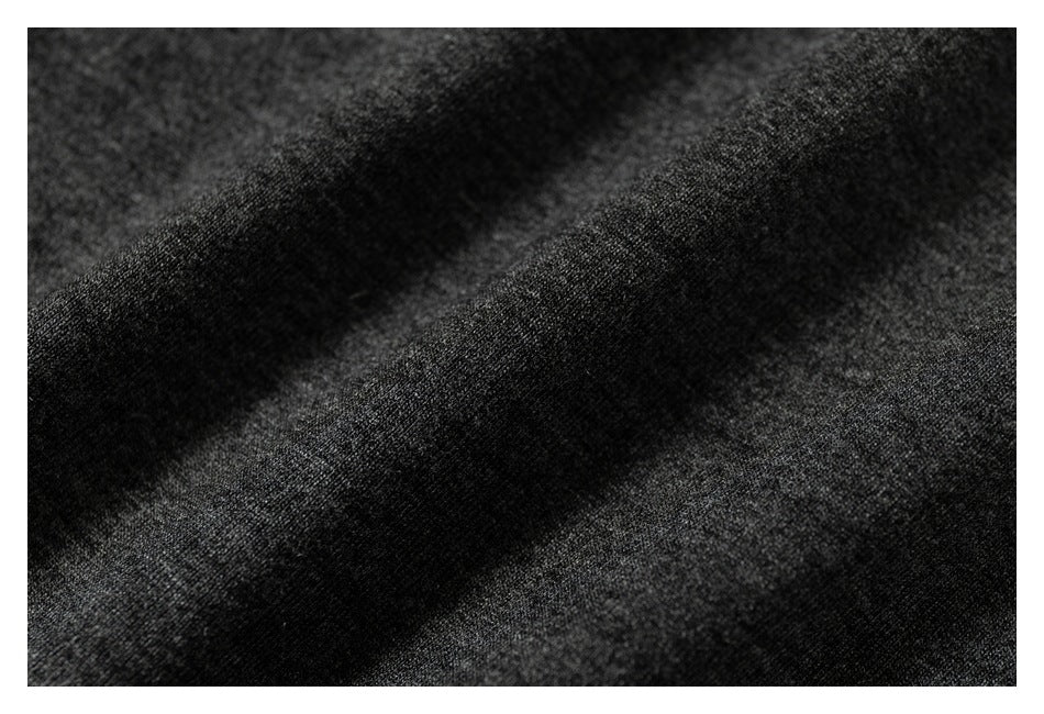 Macro view of dark charcoal heathered fabric with a soft, textured surface.