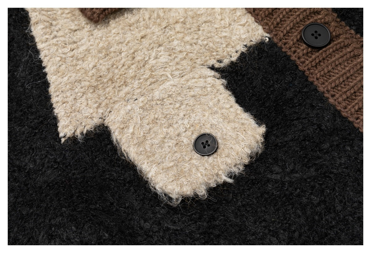 Close-up of the cardigan’s cream fuzzy panel, black body, and brown buttoned trim.