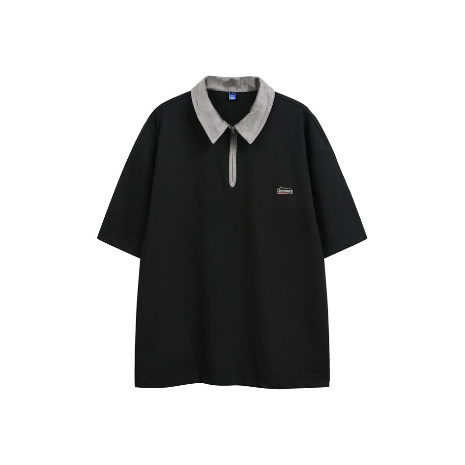 Black short-sleeve quarter-zip polo top with a gray textured collar and a small chest logo patch, front view