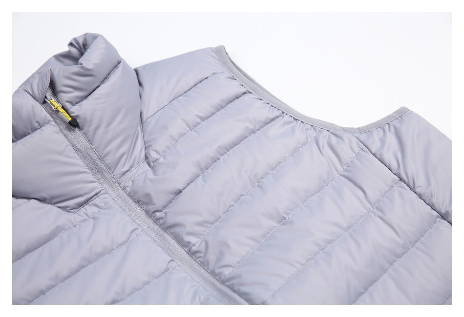 Close-up of a light gray-lavender quilted vest showing its high collar, front zipper and neckline.