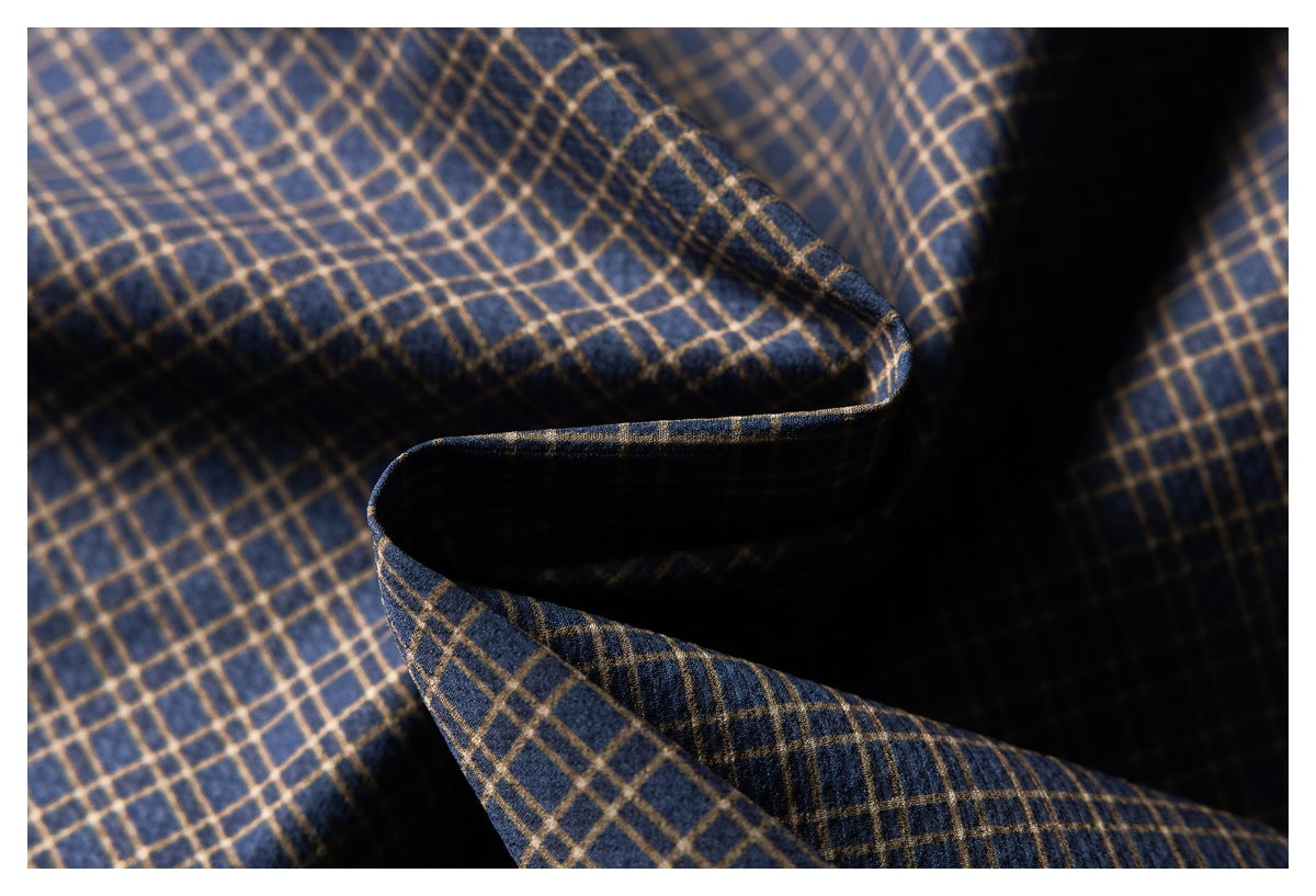 Close-up of navy fabric with a tan plaid pattern, folded to show the material and pattern.