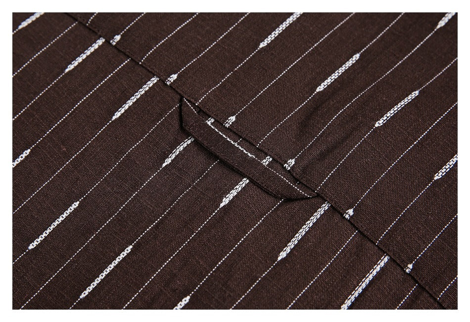 Close-up of a folded seam on brown fabric with thin white dashed stripes.