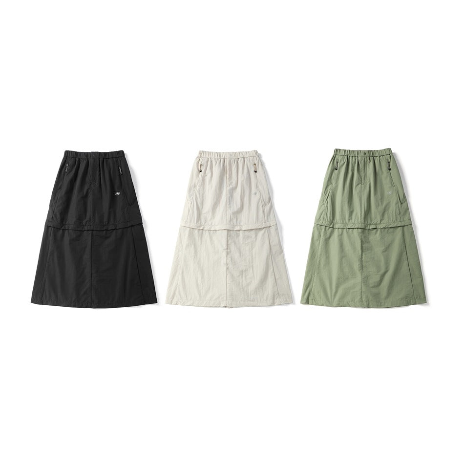 Three long skirts shown from the front in black, off-white, and sage green.