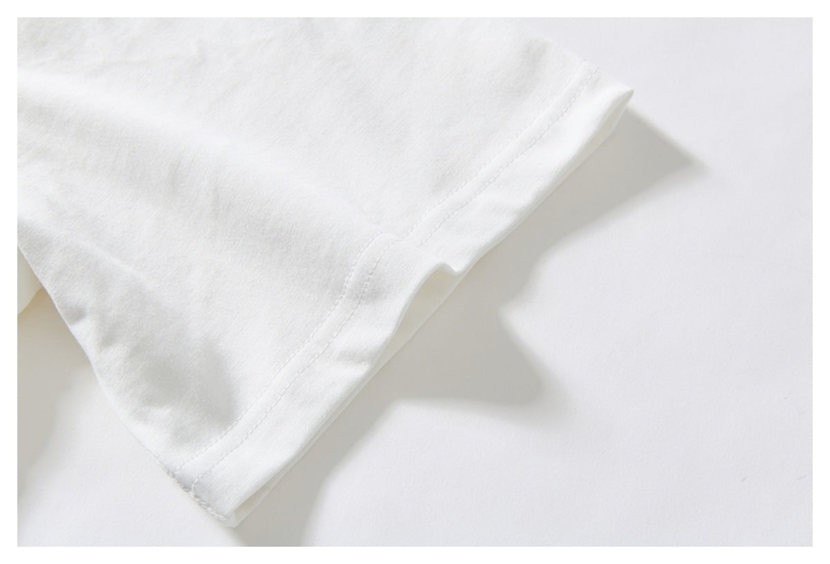Close-up of a white shirt sleeve edge and stitched cuff hem.