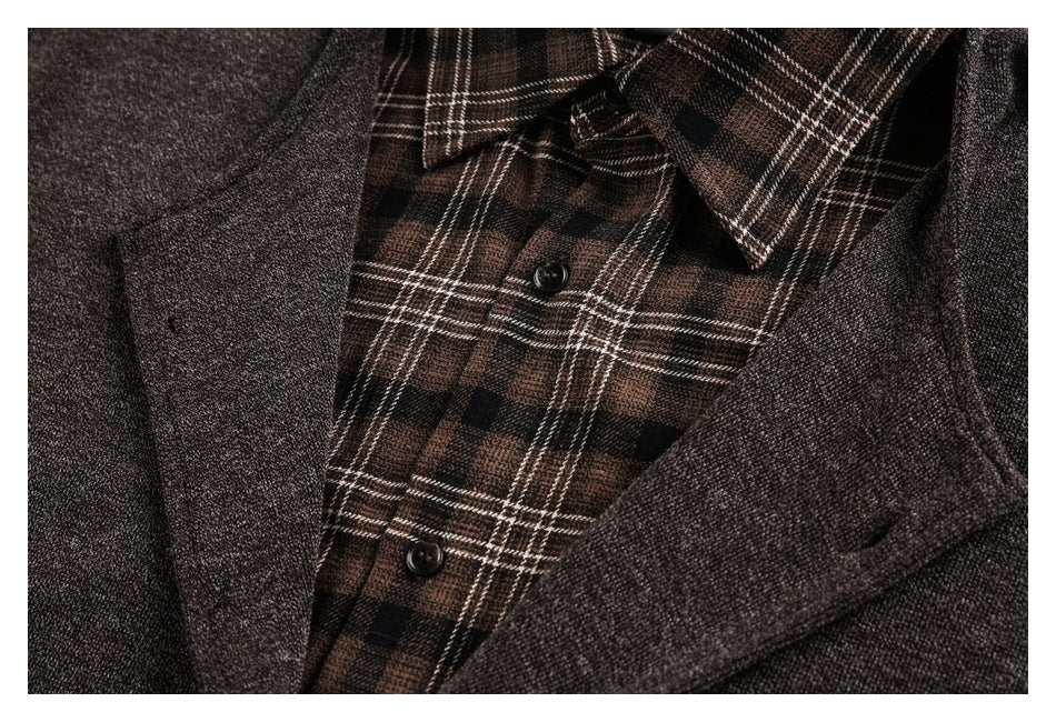 Close-up of a dark brown textured jacket over a brown and black plaid button-front shirt.