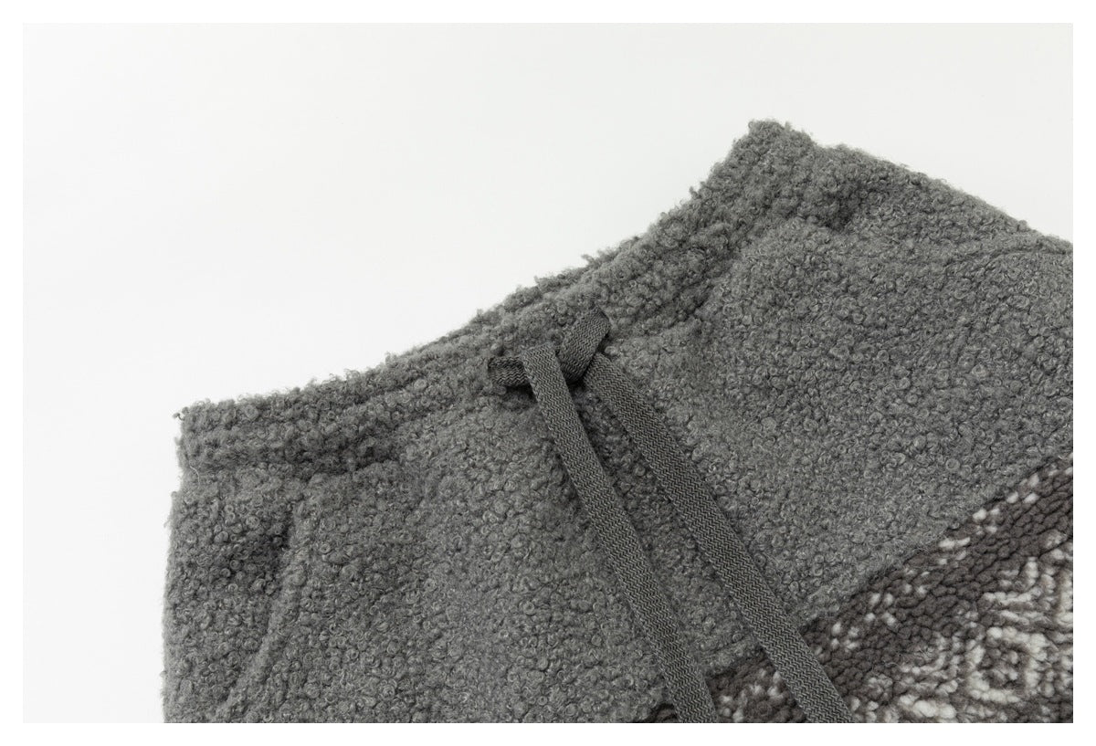Gray loop-textured waistband detail with dark drawstrings and a patterned panel at the edge.