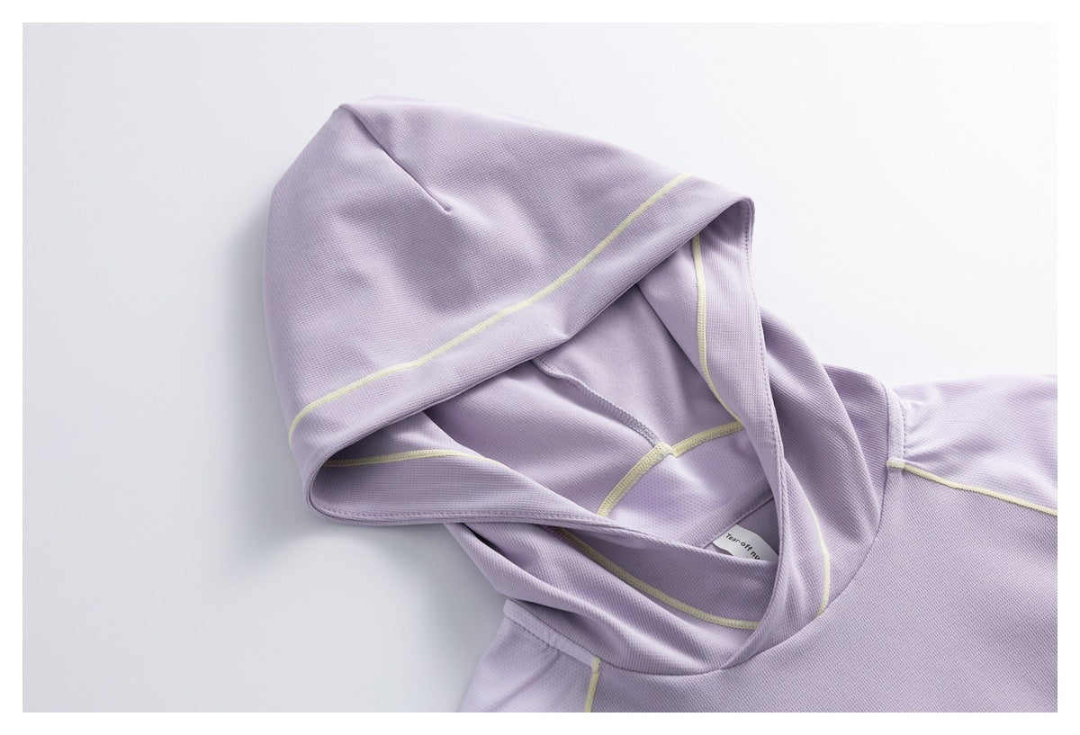 Close-up of a lavender hooded top showing the hood, pale yellow seam piping and part of the shoulder.