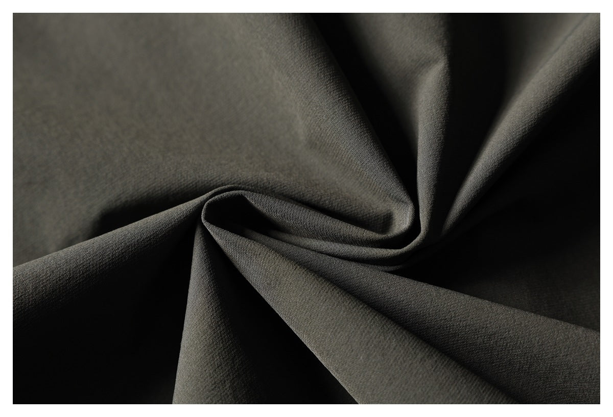 Close-up of dark olive fabric gathered into soft folds.