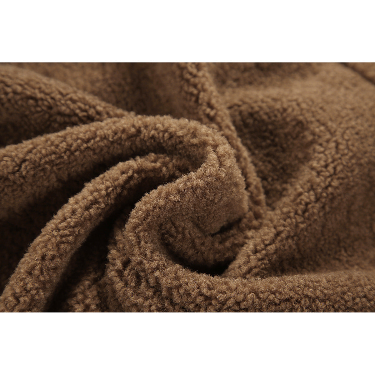 Macro view of the plush, curly brown texture of a fleece jacket.