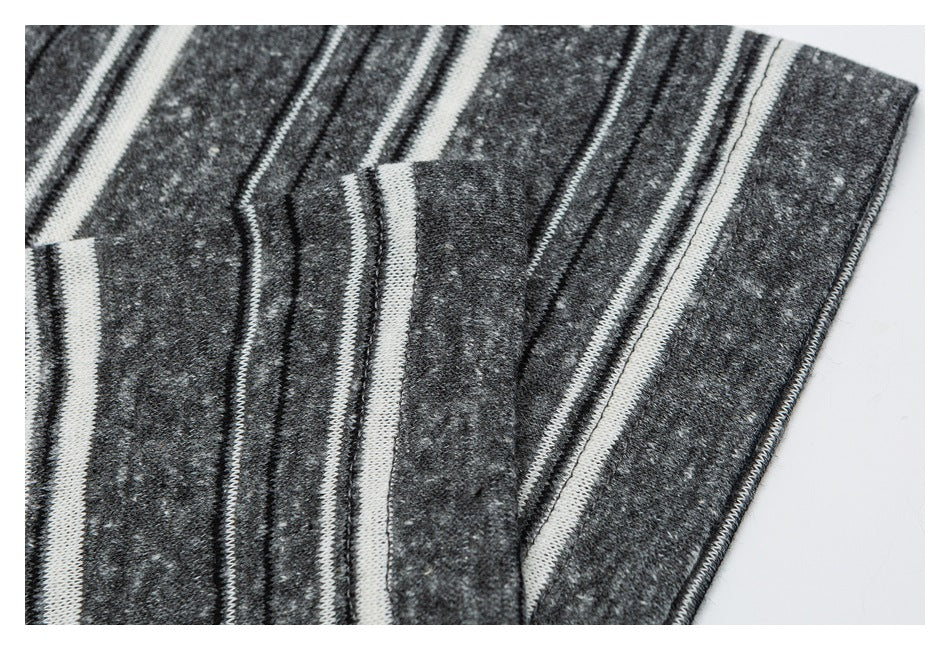 Close-up of the charcoal gray shirt's striped sleeve and edge stitching.