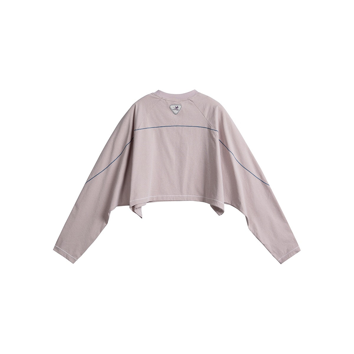 Back view of a pale pink cropped long-sleeve top with dark curved piping across the back and sleeves.