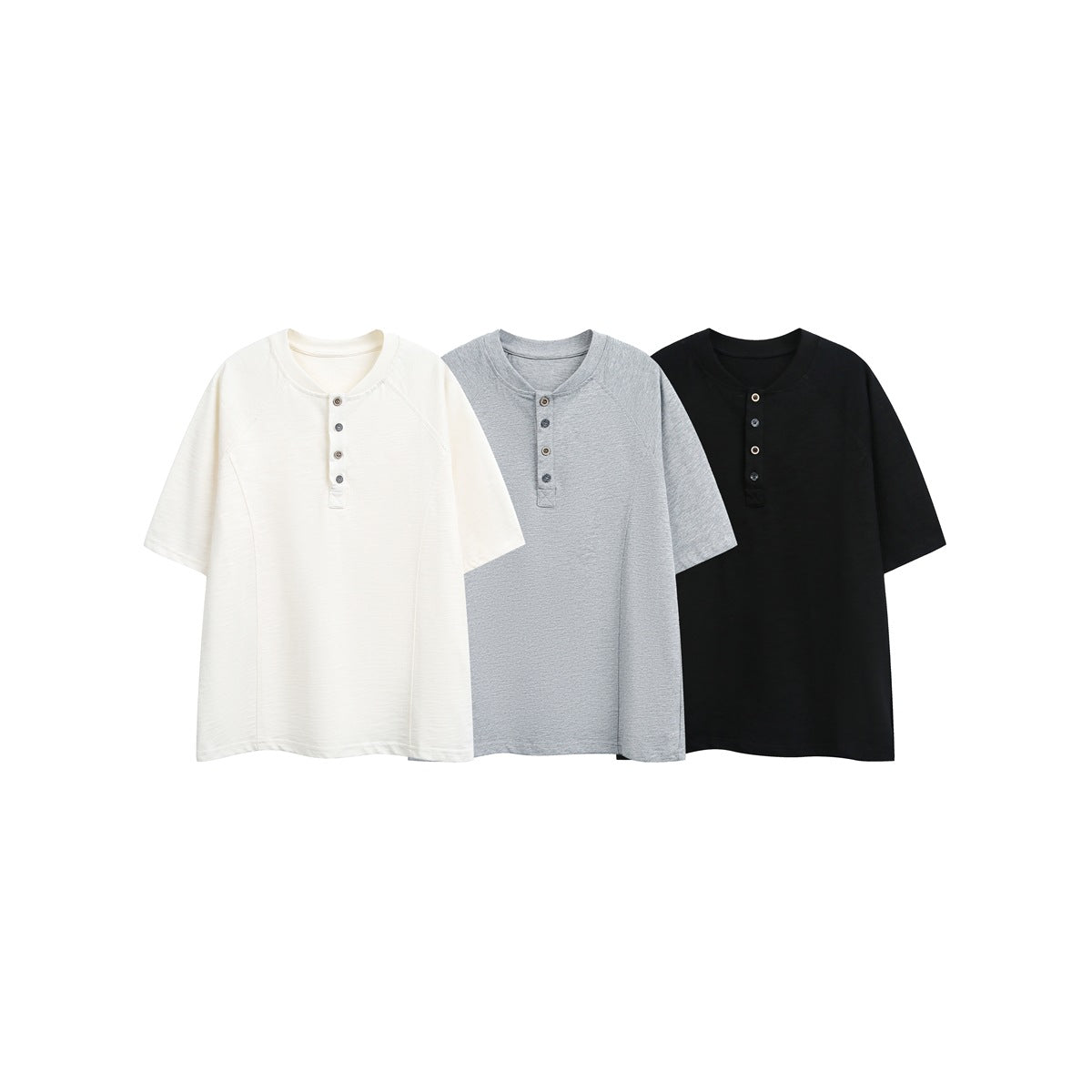 Three short-sleeve Henley T-shirts with raglan seams and four-button plackets in ivory, heather gray, and black.