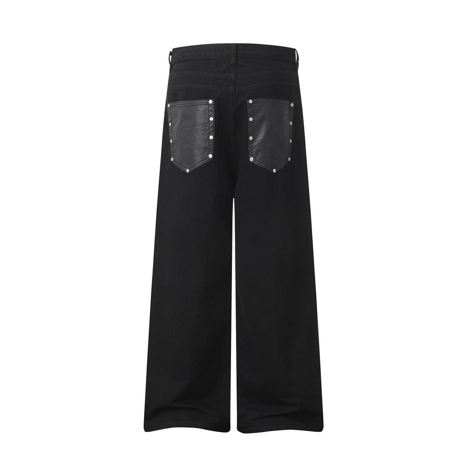 Back view of black wide-leg pants with two dark riveted back pockets.